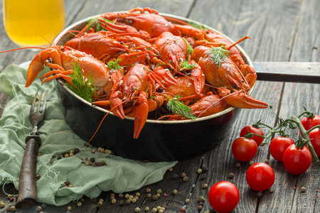 Boiled crayfishes with dill and tomatoes on wooden tableの写真素材