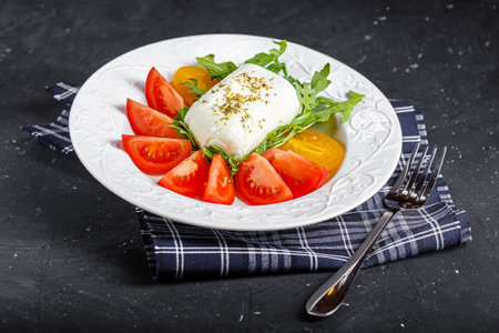 Caprese salad with tomatoes, arugula and mozzarella cheeseの写真素材