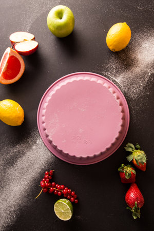 Fruit cake with strawberries, lemon and lime on a black backgroundの写真素材