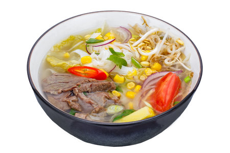 Thai noodle soup with pork and vegetables isolated on white background