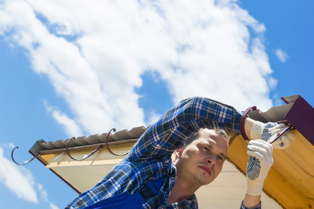 Worker repairing the roof of the sky