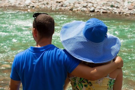a pair of lovers watching the stormy riverの写真素材