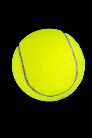 yellow tennis ball on blackの写真素材