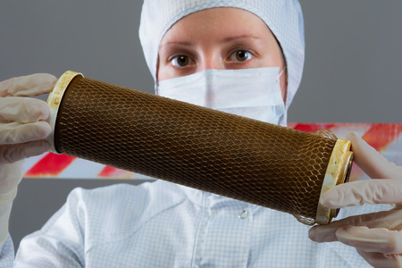in the hands of the scientist filter cleaning dirt