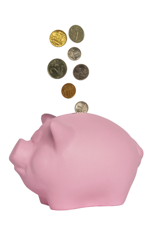 Coins piled in a pink piggy bank pigの写真素材