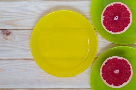 on the table a plate with red grapefruitの写真素材