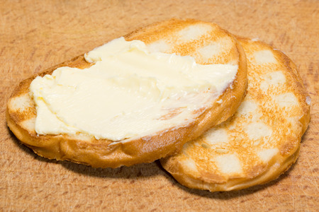 two pieces of fried bread and butter on the tableの写真素材