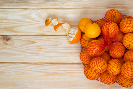 bag of tangerines on the table is scatteredの写真素材