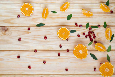 scattered fruit on the table pomegranate and tangerineの写真素材