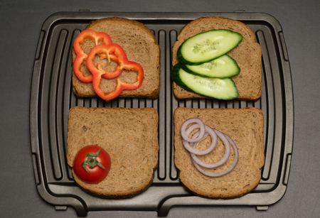 four pieces of bread and vegetables are grilledの写真素材