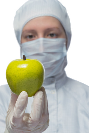 Scientist holding a green apple in the handsの写真素材