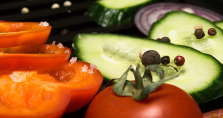sea salt crystals on vegetables and peppercornsの写真素材