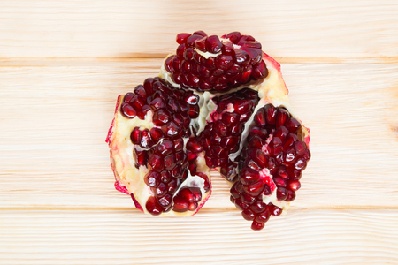 ripe pomegranate on a wooden tableの写真素材
