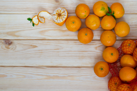 tangerines scattered on a wooden board and there is a place for an inscriptionの写真素材