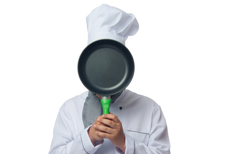 Chef shows a frying pan on which to make an inscriptionの写真素材