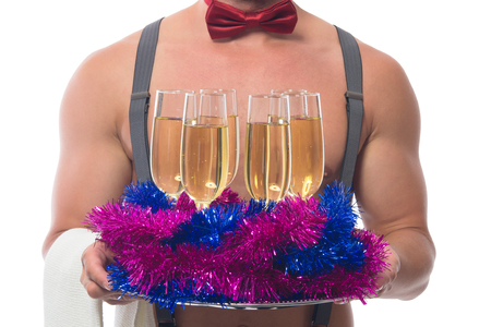 two glasses of champagne on the background of beautiful muscular body waiterの写真素材