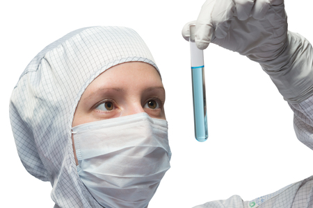 woman in a protective suit looking at a blue liquidの写真素材