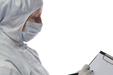 woman in a protective suit is writing on paperの写真素材