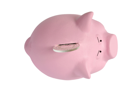 a large silver coin will not go in a pink piggy bankの写真素材