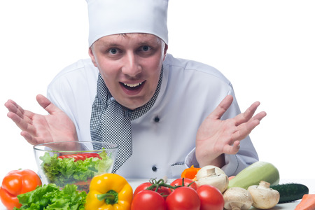 chef showing his hands in front of a vegetable saladの写真素材