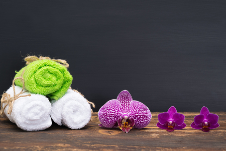 towel spa with beautiful flowers on a dark backgroundの写真素材