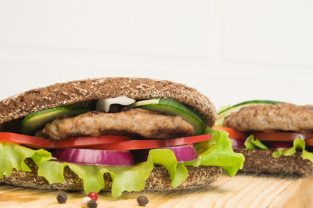 ready sandwiches with meat and vegetables on the tableの写真素材