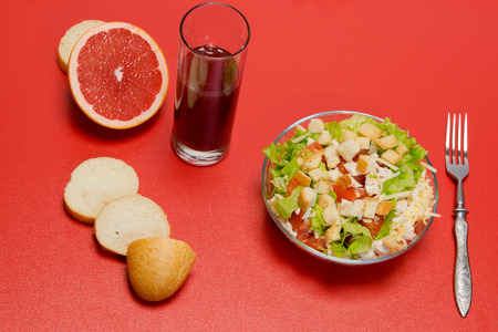 Fresh Caesar salad with grefrutovym juice on the tableの写真素材