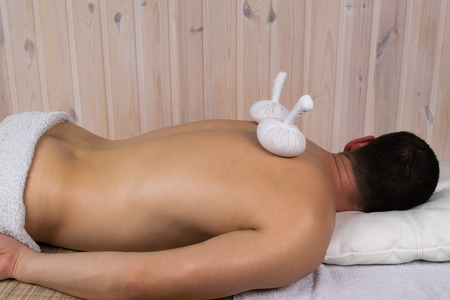man lies on a massage table nakedの写真素材