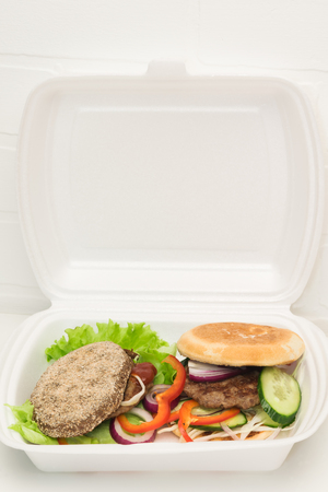 sandwich with vegetables and meat in the container, the top place for an inscriptionの写真素材