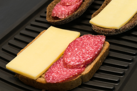 nice sandwich with sausage and cheese on toast backgroundの写真素材