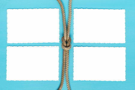 four sheets of paper with a rope on a blue backgroundの写真素材