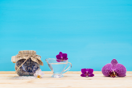 Purple orchid flower with massage oil on the tableの写真素材