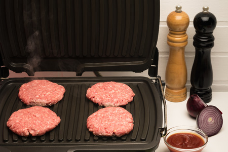 the table preparing minced meat on the grillの写真素材