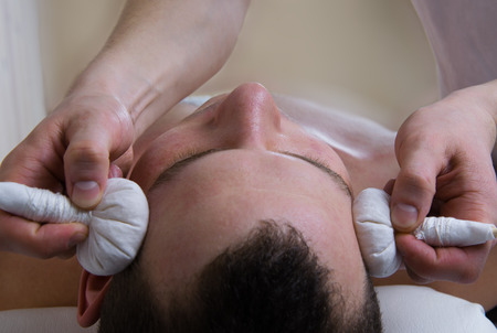 herbal bags massage on temples headの写真素材