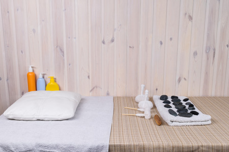 massage table with stones and bags for massageの写真素材