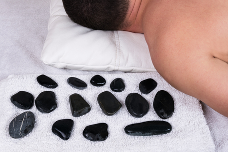 massage with warm stones manの写真素材