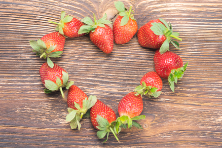 on a table lined with red strawberry heartの写真素材