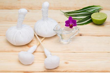 Light wood background with a set of bags and massage oil orchidの写真素材