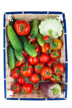 Basket with vegetables for salad on white backgroundの写真素材