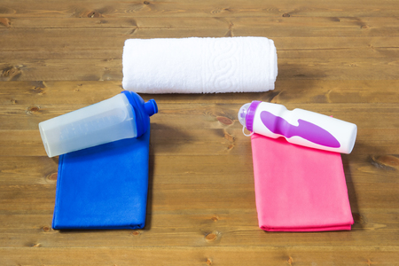 Two towels and bottles for sports for men and womenの写真素材