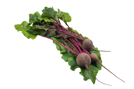Beets with green tops on horseradish sheet
