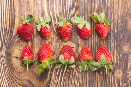 two rows of strawberries on a dark tableの写真素材