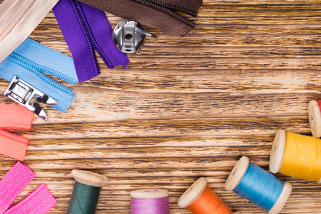 A wooden background with multi-colored threads on it and lightningの写真素材