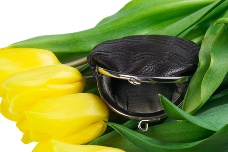 Empty purse lies on golden tulips, on white backgroundの写真素材
