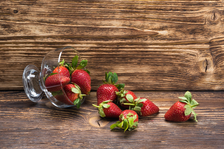 fell out cup with strawberries on a dark background boardの写真素材