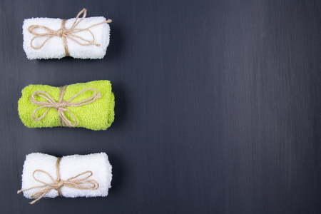 Three different towels are lying on a black backgroundの写真素材