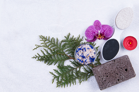 Set for foot care on white towel and flowersの写真素材