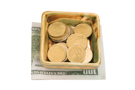 the coins in the plates are on dollars on white backgroundの写真素材