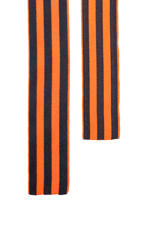 St. George's Ribbon two ends of orange black on a white isolated backgroundの写真素材