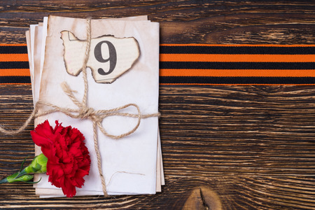 George ribbon on the blackboard under letters and a red flower